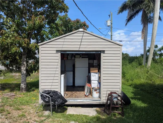 Utility shed featuring horizontal siding, a gabled roof, and a single-door entry