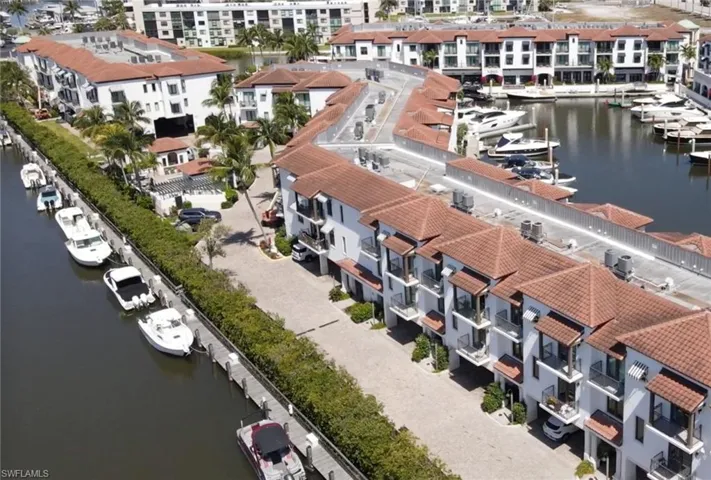 Aerial view of a Curlew Canal and The Naples Bay Club Residences