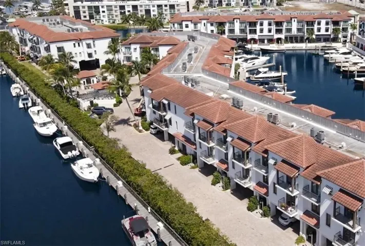 Aerial view of a Curlew Canal and The Naples Bay Club Residences