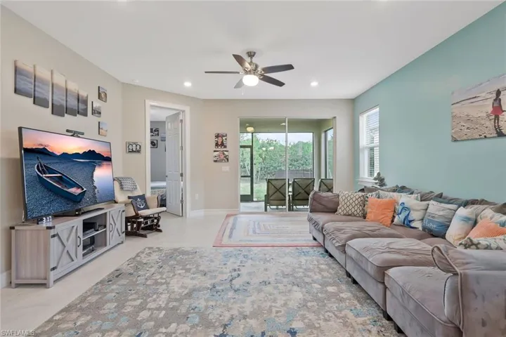 Living room with ceiling fan and recessed lighting