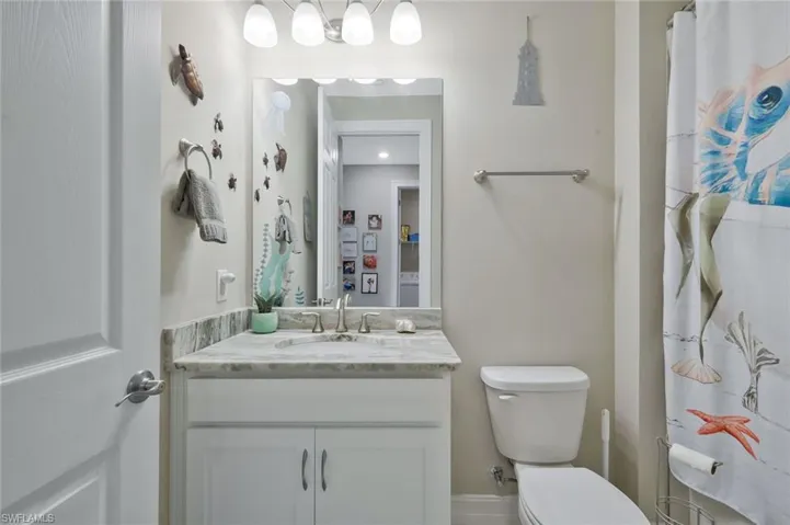 Full bathroom with a shower with shower curtain and vanity