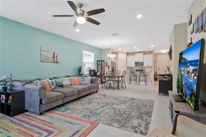 Living area with a chandelier, recessed lighting, and ceiling fan