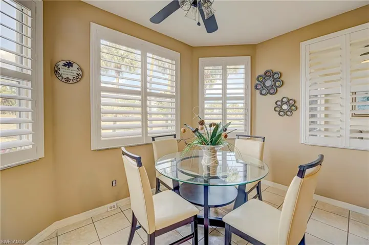 Dining space with tile patterned floors and ceiling fan