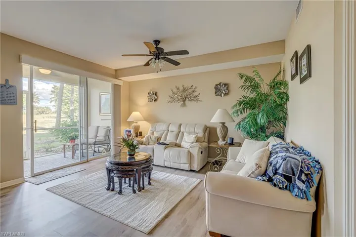 Living room with ceiling fan and wood finished floors