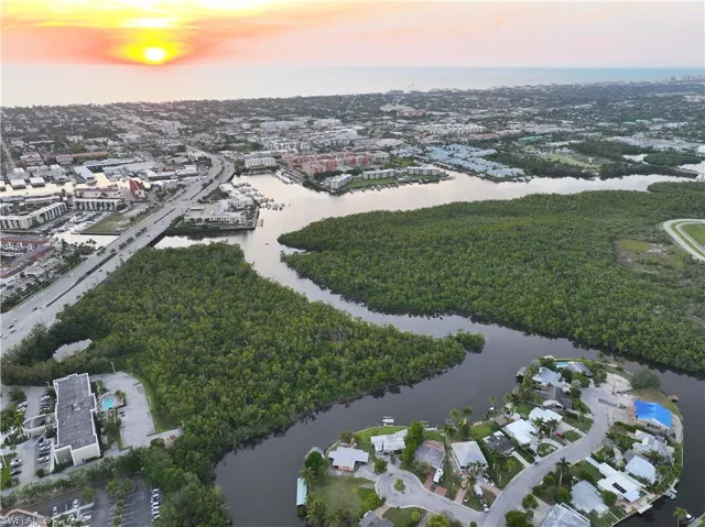 Aerial view at dusk featuring a water view