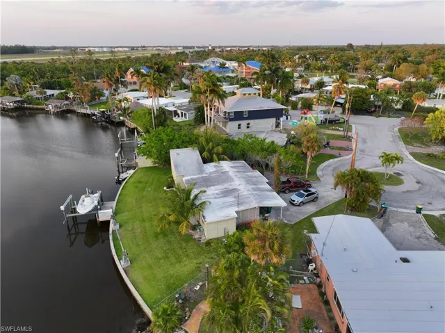 Aerial view at dusk featuring a water view