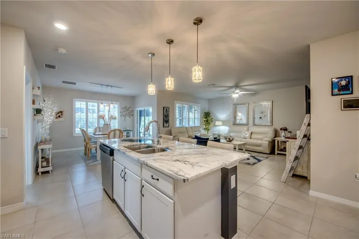 Kitchen island with a light-toned countertop and an undermount sink