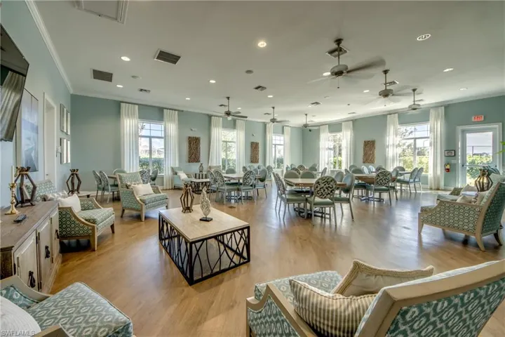 Spacious room featuring wood-finish flooring, recessed lighting, and multiple ceiling fans