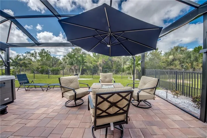 Screened outdoor living area featuring a paver patio