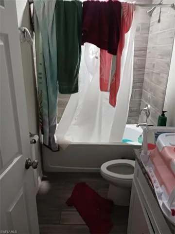 Bathroom featuring shower / bath combo and vanity