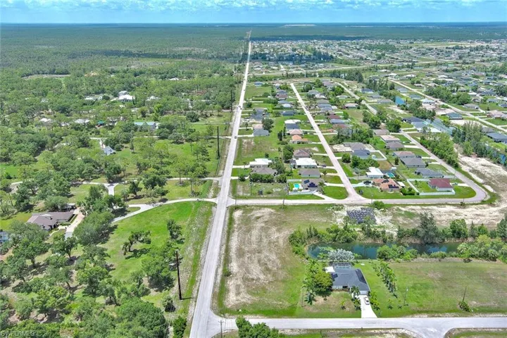 View of property location with a large body of water and nearby suburban area