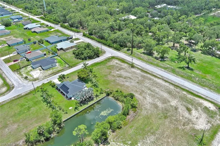 Aerial view of residential area featuring a large body of water