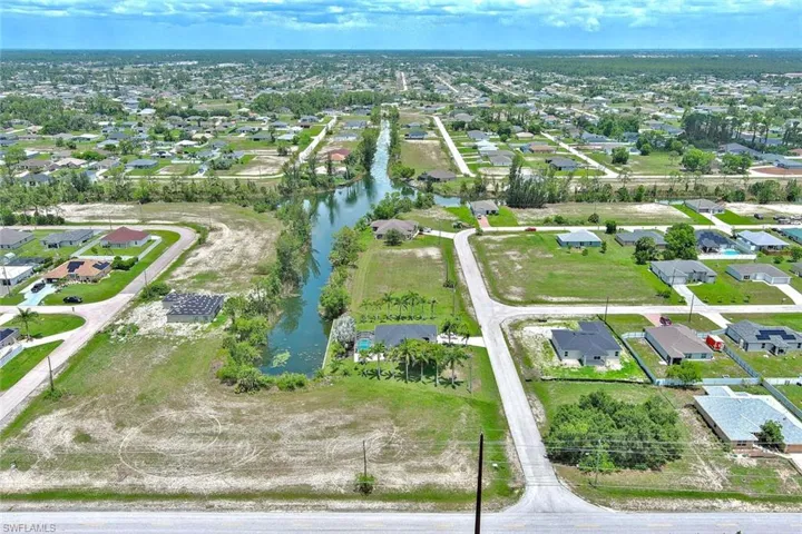 Aerial view of property's location with nearby suburban area and a nearby body of water