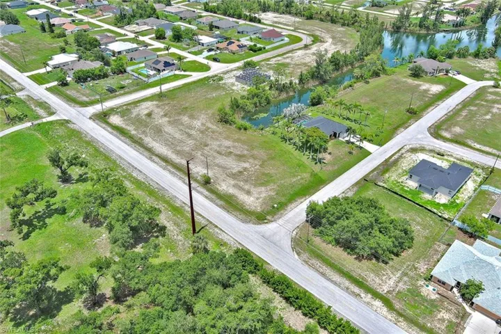 Aerial overview of property's location with nearby suburban area and a large body of water