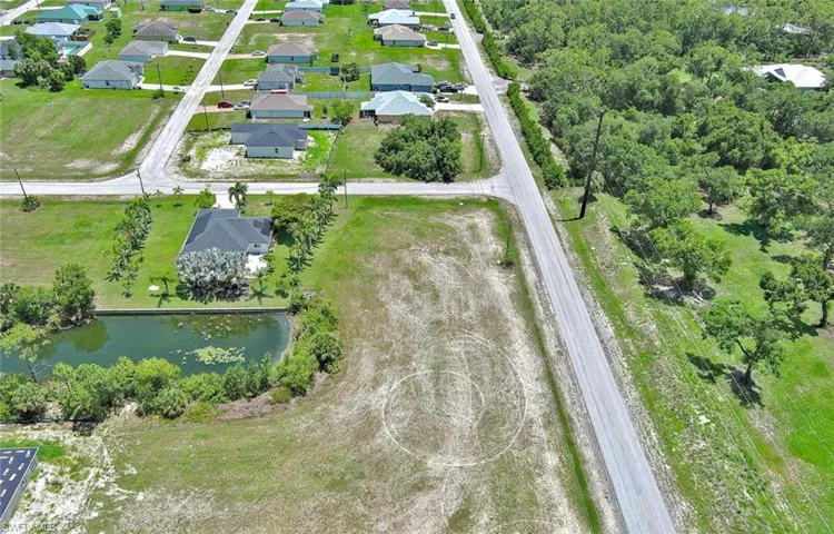 Aerial view of property and surrounding area with a nearby body of water