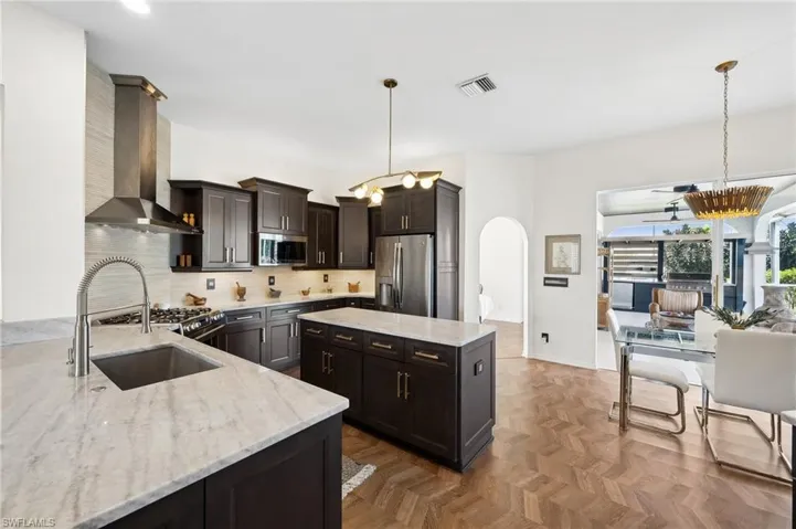 Contrasting cabinetry and warm wood floors create a timeless look.