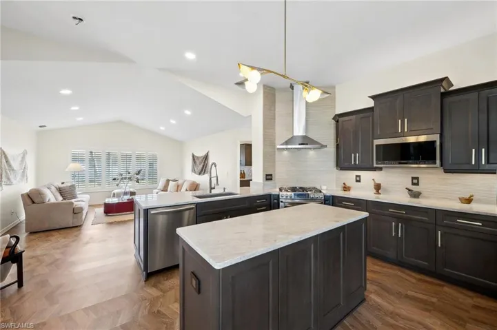 Modern Elegance - Dark wood cabinetry, sleek quartz countertops, and stainless steel appliances.