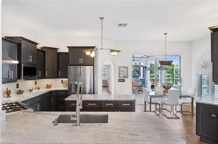 Seamless Indoor-Outdoor Living – Glass doors open to a spacious lanai, perfect for entertaining.