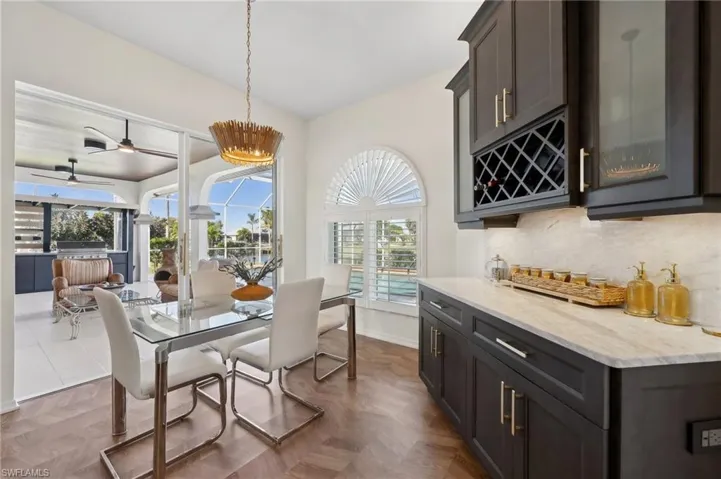 Stylish Dining with a View – Enjoy pool and canal views from this elegant dining space.
