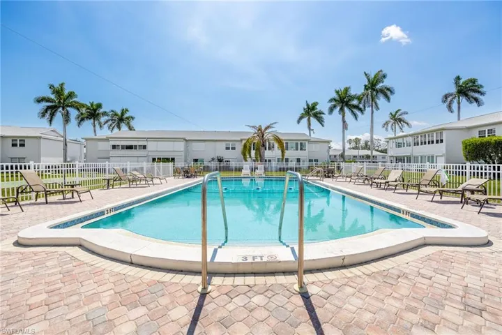 Community pool featuring a patio area and a residential view