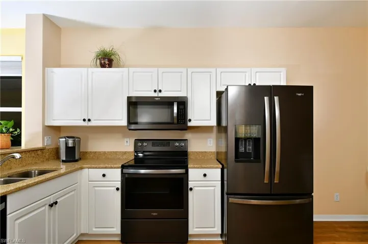 Kitchen with Whirlpool black stainless appliance package