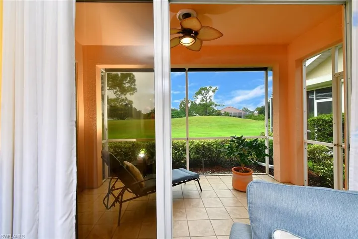 Sliders leading to the screened in under truss lanai with a view to the 17th green