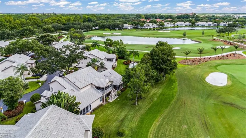Aerial view with view of golf course, a water view, and a residential view