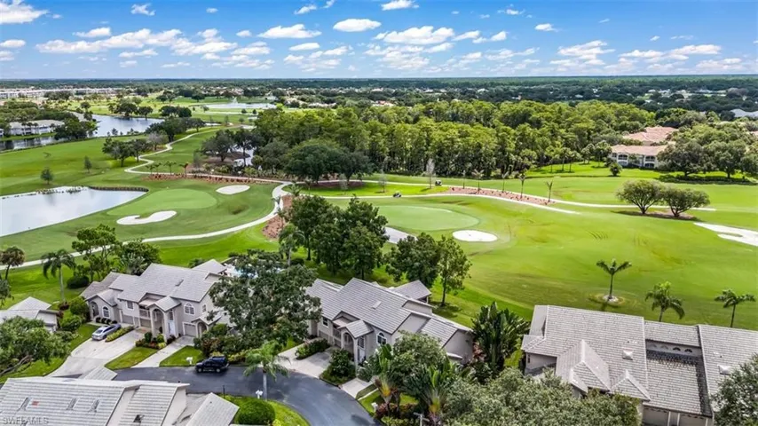 Aerial view featuring a water view and view of golf course