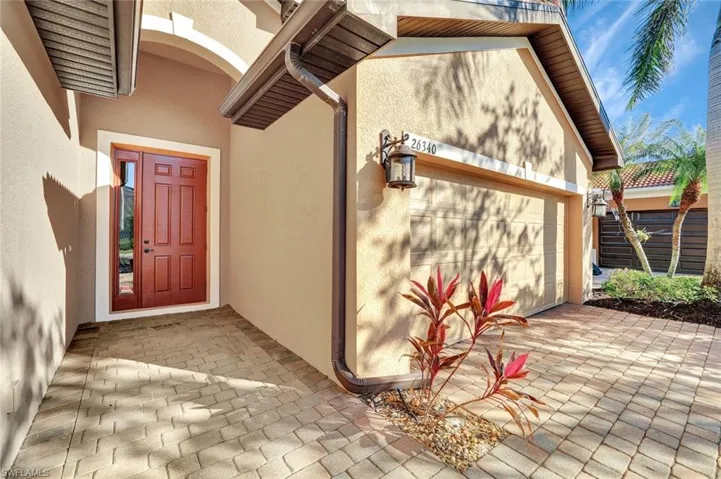 Doorway to property with a garage