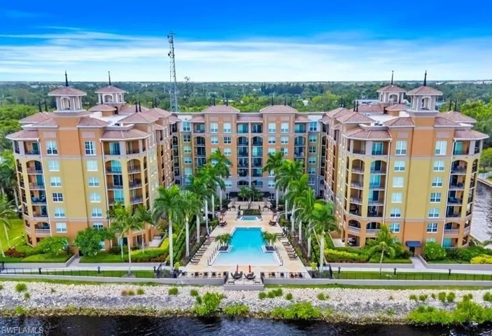 Drone / aerial view of a pool area and a large body of water