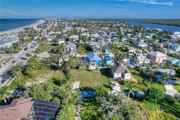 Aerial overview of property's location with expansive coastline and nearby suburban area