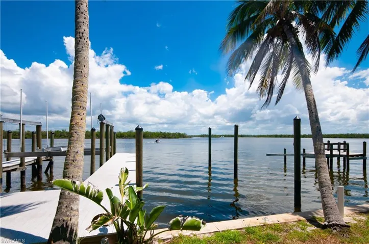 Aerial overview of property's location with waterfront with a beach and property boundaries highlighted