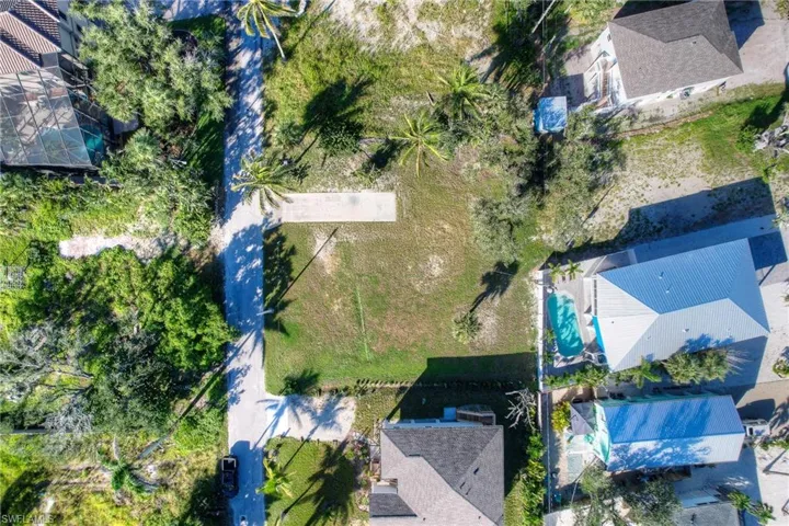 Aerial view of residential area featuring waterfront with a beach