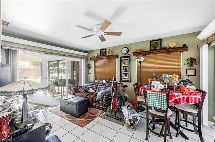Living room featuring ceiling fan and light tile patterned floors