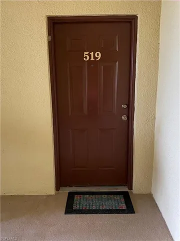 Property entrance featuring stucco siding