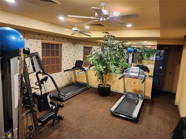 Workout area with ceiling fan and recessed lighting