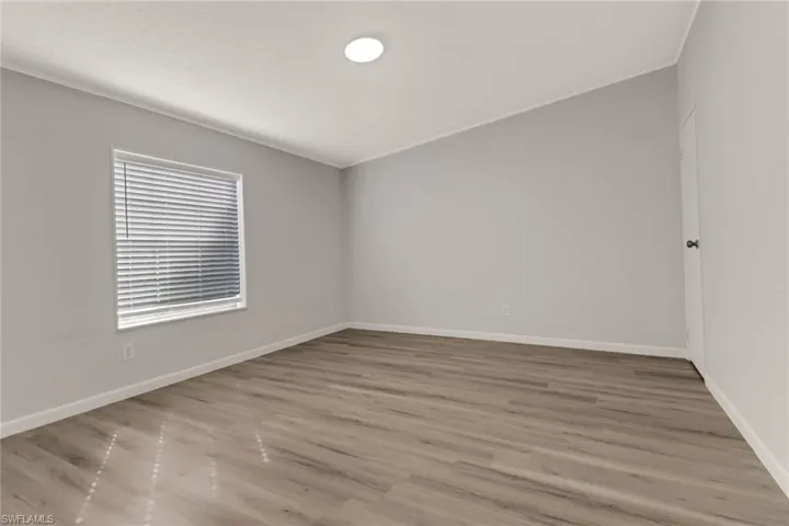 Empty room featuring light hardwood / wood-style floors and crown molding