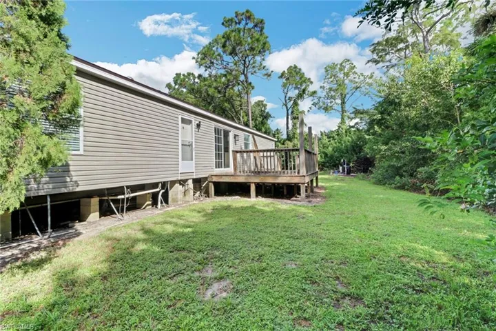 View of yard featuring a wooden deck