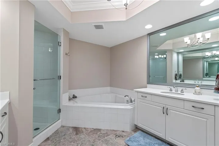 Primary bath featuring separate vanities, tub and walk-in shower