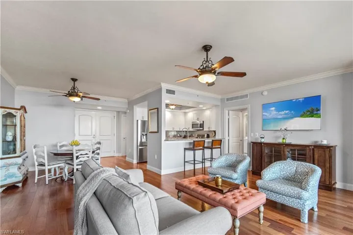 Living area featuring crown molding, and plenty of natural light