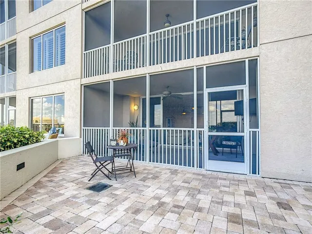 View of patio featuring a sunroom and a ceiling fan