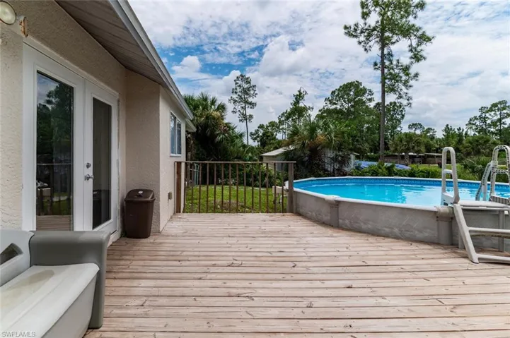 View of swimming pool with a wooden deck