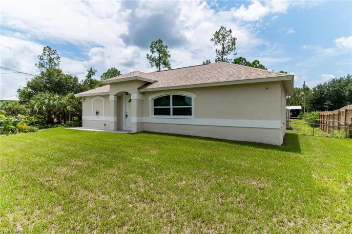 Rear view of house featuring a lawn
