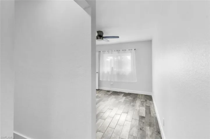 Corridor featuring light wood-type flooring