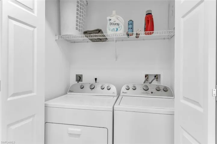 Washroom with washer and clothes dryer