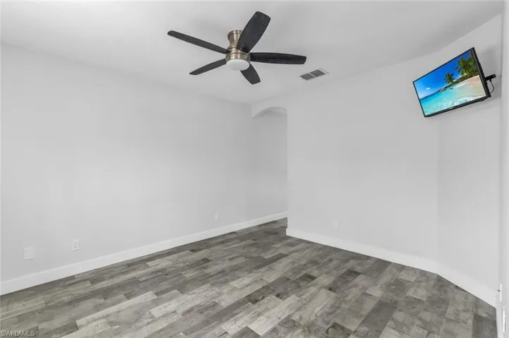 Unfurnished room with ceiling fan and hardwood / wood-style floors