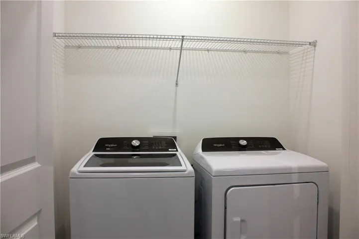 Dedicated laundry area featuring a wire shelving unit, providing storage