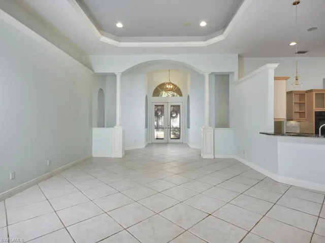 Entryway with elegant archways and tile flooring throughout.