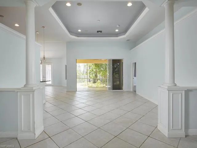 Bright, open and inviting living area with ceiling detail and direct access to the lanai.