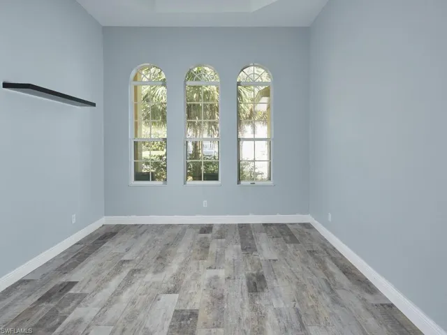 Flexible space ideal for office, or den with arched window detail.